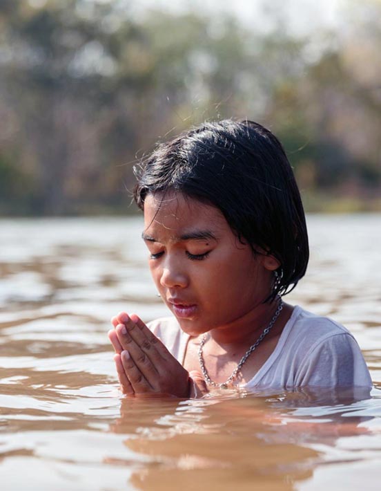 Thai child being baptized